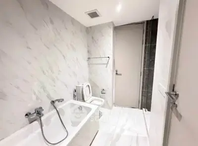 Modern bathroom with marble tiles and bathtub in luxury apartment