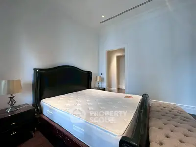 Spacious bedroom with elegant bed and stylish decor, perfect for comfort and relaxation.