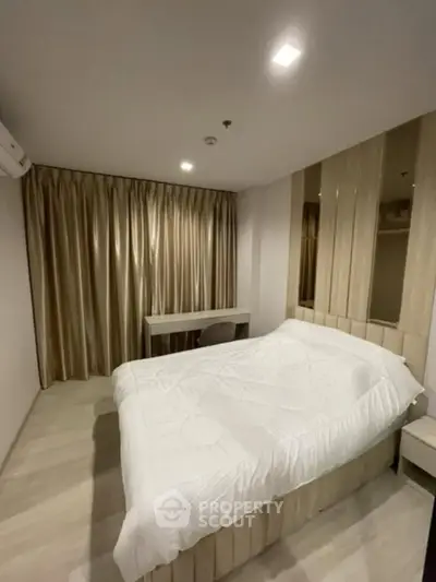 Modern bedroom with elegant curtains and cozy bed in a stylish apartment.