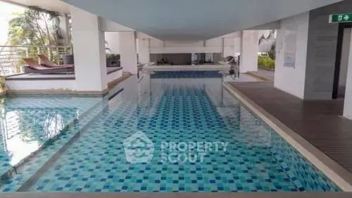 Luxurious indoor pool area with modern design and relaxing lounge chairs.