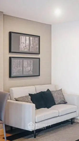 Stylish living room with modern sofa and framed wall art