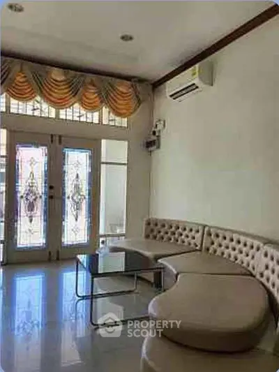 Elegant living room with stylish furniture and large windows for natural light.