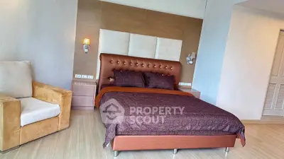 Luxurious bedroom with elegant decor and comfortable seating area.