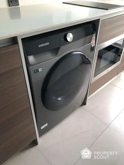 Modern kitchen with built-in Samsung washing machine and sleek cabinetry