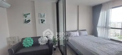 Modern bedroom with large windows and cozy decor in a high-rise apartment.