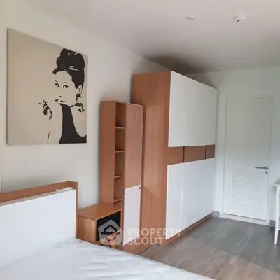 Modern bedroom with stylish wooden furniture and elegant wall art