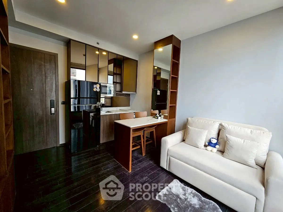 Modern living room with sleek kitchen and cozy sofa in open layout apartment