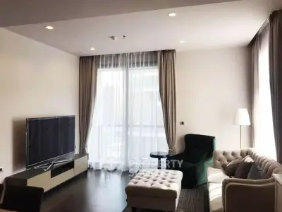 Elegant living room with modern furniture and large window for natural light.