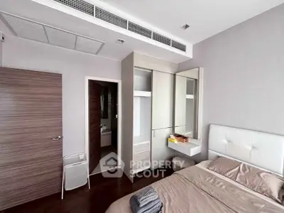 Modern bedroom with sleek design, featuring built-in wardrobe and cozy bed setup.