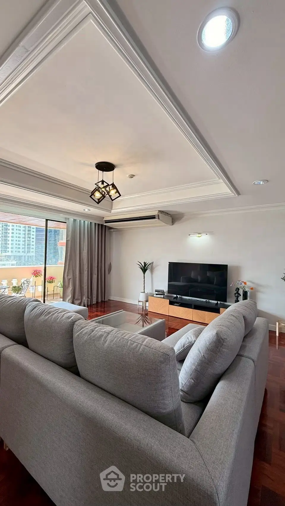 Spacious living room with modern decor and large balcony access
