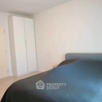 Cozy bedroom with modern wardrobe and comfortable bed in a stylish apartment.