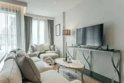 Elegant living room with modern decor and large windows for natural light.
