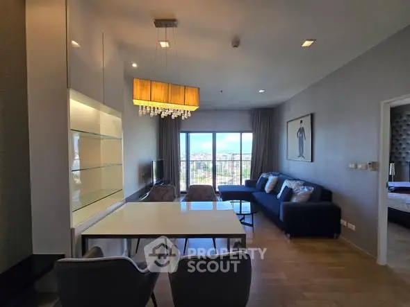 Modern living room with elegant decor and stunning city view from large windows.