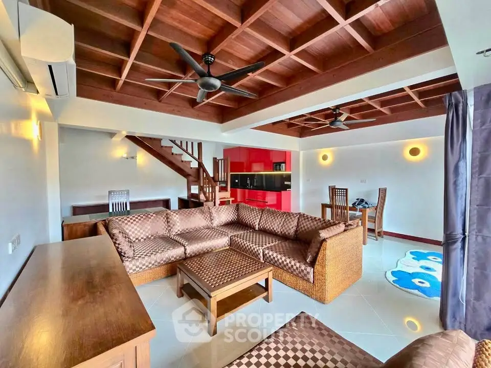 Spacious living room with modern furniture and wooden ceiling accents