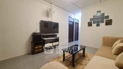 Cozy living room with modern TV setup and comfortable seating