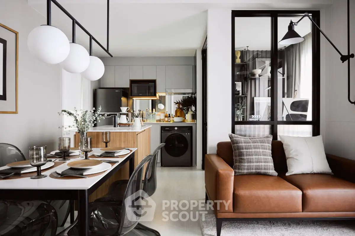 Modern open-plan kitchen and living room with stylish decor and contemporary furniture.