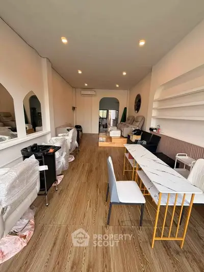 Spacious interior with modern decor and wooden flooring, ideal for commercial or residential use.