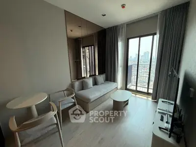 Modern living room with city view, featuring sleek furniture and floor-to-ceiling windows.