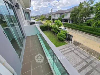 Spacious balcony with scenic neighborhood view in modern residential area.