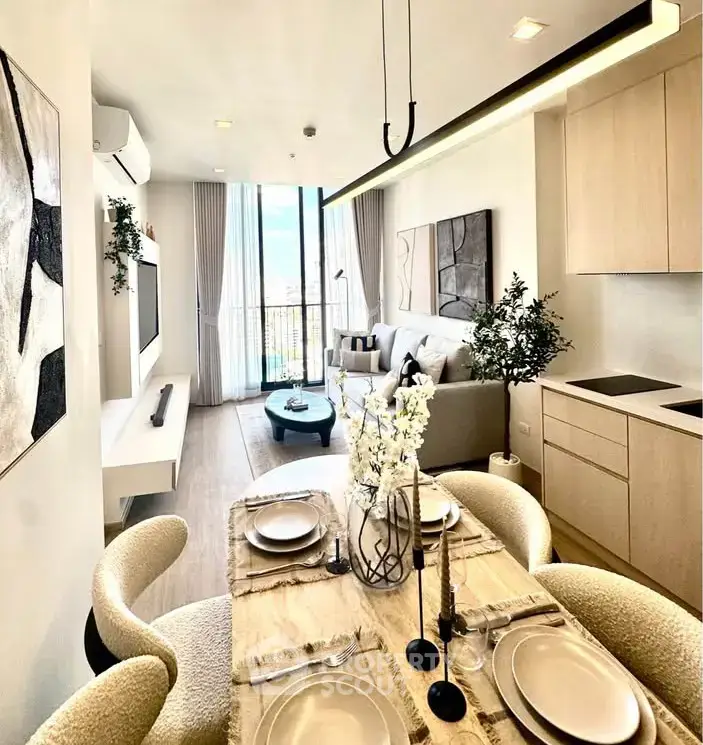 Modern open-plan living room and dining area with elegant decor and natural light.