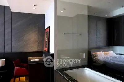Luxurious modern bedroom with ensuite bathroom featuring sleek design and elegant furnishings.
