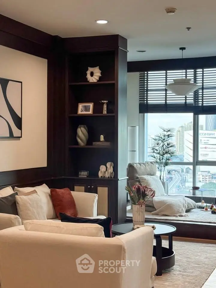Luxurious living room with modern decor and city view, featuring elegant furniture and stylish shelving.