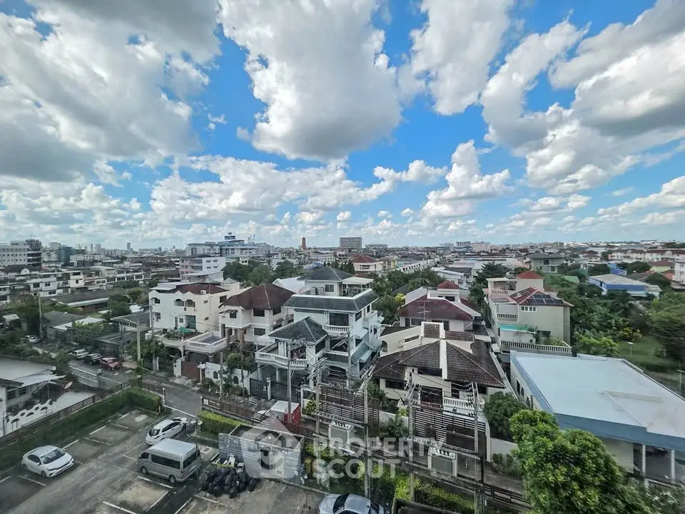 Stunning aerial view of a residential neighborhood with clear blue skies and scattered clouds.