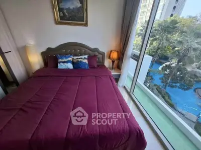 Luxurious bedroom with stunning pool view and elegant decor in modern high-rise apartment.