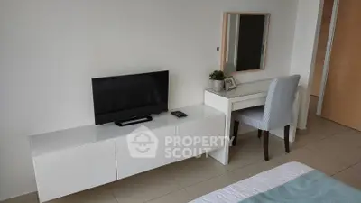 Modern bedroom with sleek TV stand and stylish vanity desk