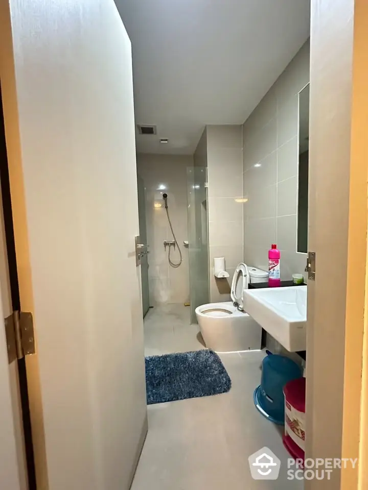 Modern bathroom with shower and sleek fixtures in a contemporary home.