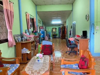 Spacious living room with vibrant decor and ample natural light, perfect for family gatherings.