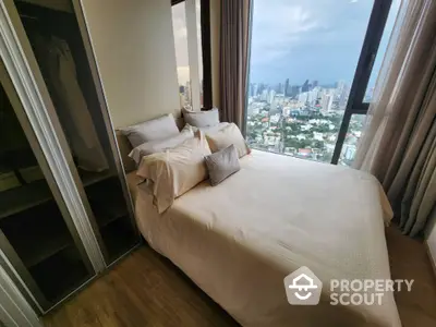 Luxurious bedroom with stunning city view and modern closet in high-rise apartment