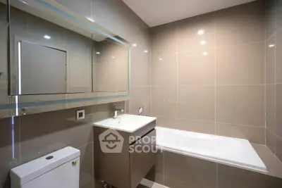 Modern bathroom with sleek design and built-in bathtub, perfect for relaxation.