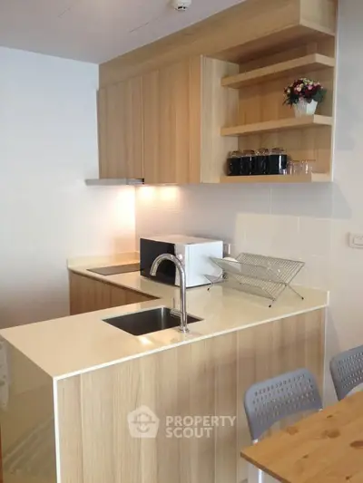 Modern kitchen with sleek wooden cabinets and built-in microwave