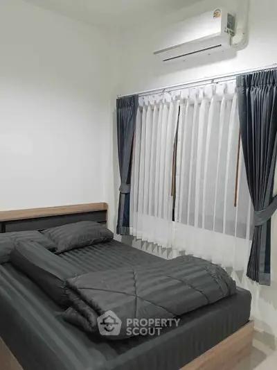 Cozy bedroom with modern air conditioning and elegant curtains