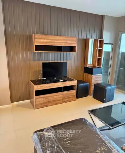 Modern living room with sleek wooden furniture and TV setup, perfect for contemporary living.