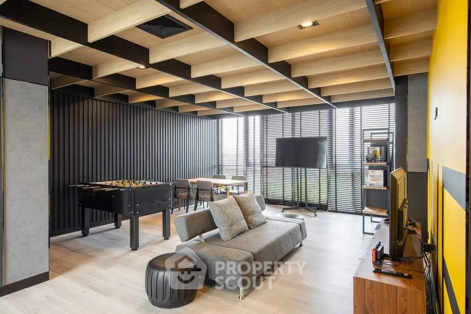 Modern living room with stylish ceiling and foosball table
