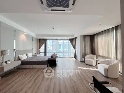 Spacious modern bedroom with large windows and elegant decor