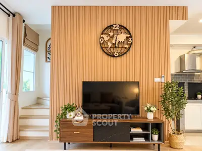 Stylish living room with modern decor and wooden accent wall featuring a world map clock.