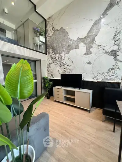 Modern living room with high ceiling and stylish marble accent wall