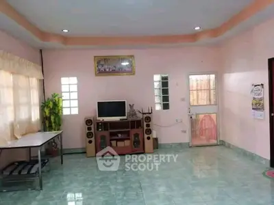 Spacious living room with tiled floors and entertainment center