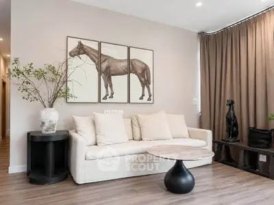 Stylish living room with modern decor and elegant artwork, featuring a cozy sofa and chic coffee table.