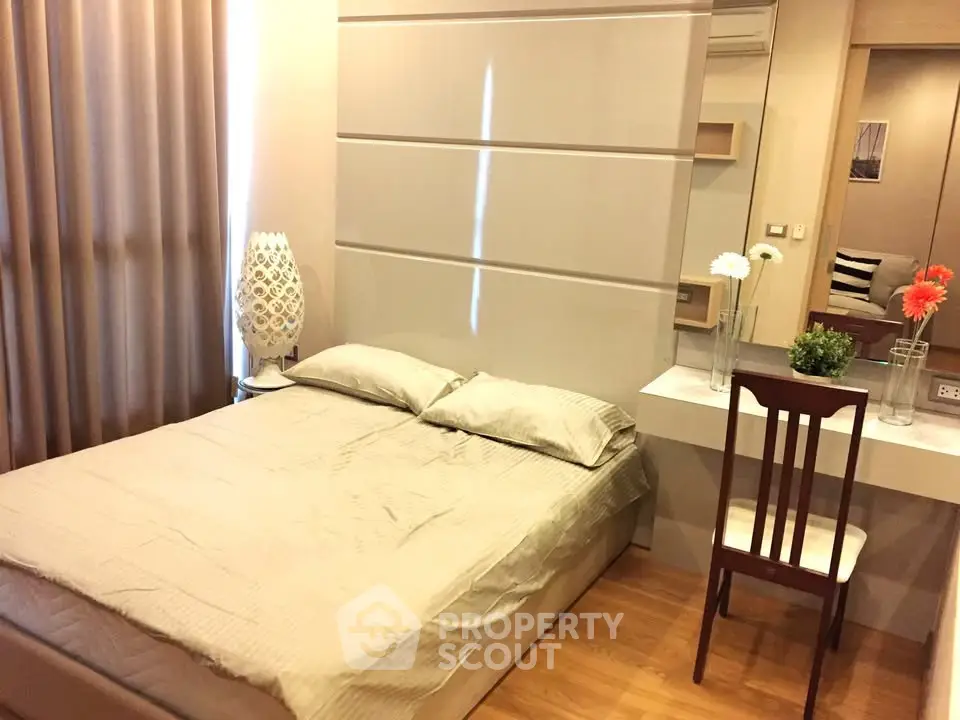 Cozy bedroom with modern decor and elegant lighting in a stylish apartment.