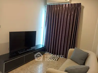 Cozy living room with modern TV setup and elegant curtains