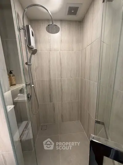 Modern bathroom with glass shower enclosure and rainfall showerhead
