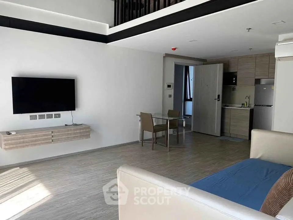 Modern open-plan living room with sleek kitchen and dining area