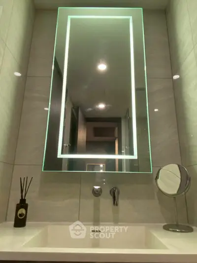 Modern bathroom with illuminated mirror and sleek sink design