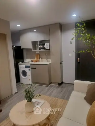 Modern compact living room with integrated kitchen and washing machine