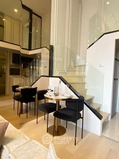 Modern duplex interior with elegant staircase and cozy dining area