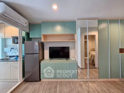 Modern living room with sleek cabinetry and integrated kitchen appliances